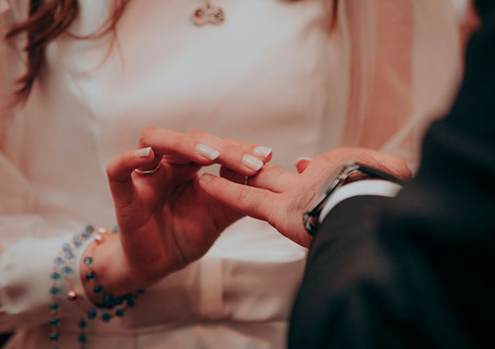 Novia poniendo el anillo a su marido en la boda